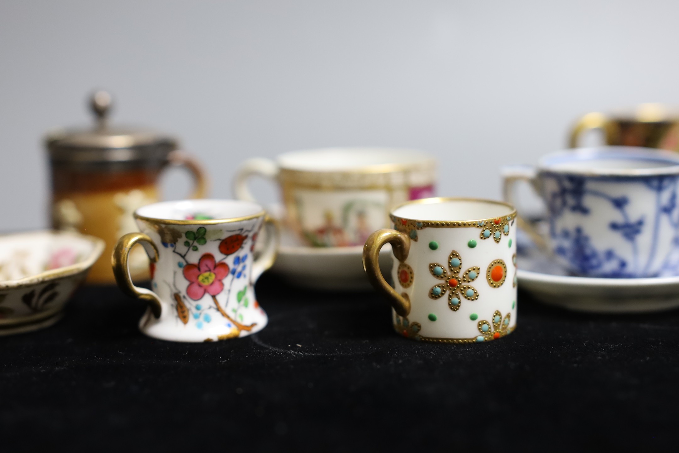 Miniatures: A Spode type Hydra jug and basin painted with flowers, a Crown Staffordshire two handled mug with flowers on a gilded blue ground, two continental cups and saucer one with Watteauesque scenes, the other in bl